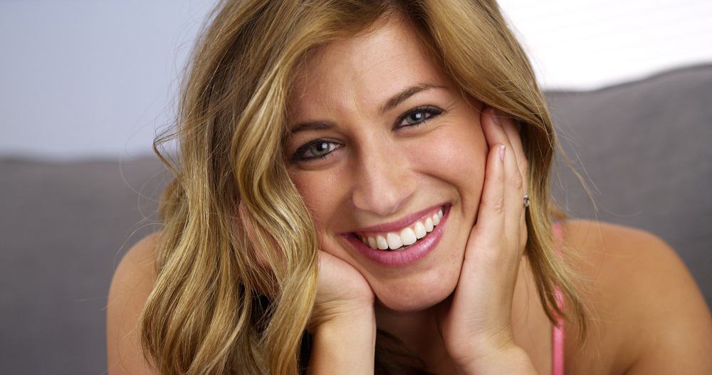 woman is smiling after wearing retainers